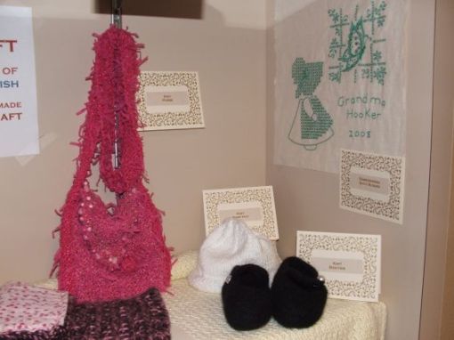 Knitted purse, knitted baby hat, embroidered quilt block, knitted felted little girl shoes and crocheted doll sleeping bag