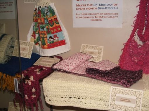 See the crocheted scarves and towel, crocheted doll sleeping bag with pillow, crocheted baby afghan and knitted purse