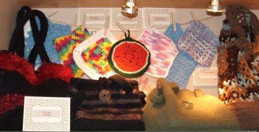 Knitted felted purses, crocheted and knitted dishclothes and pot holders, a trive and a crocheted tote bag